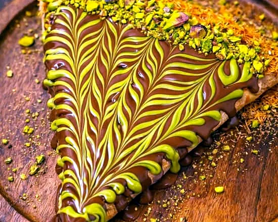 Dubai chocolate crepe with pistachio cream swirl and crushed pistachios